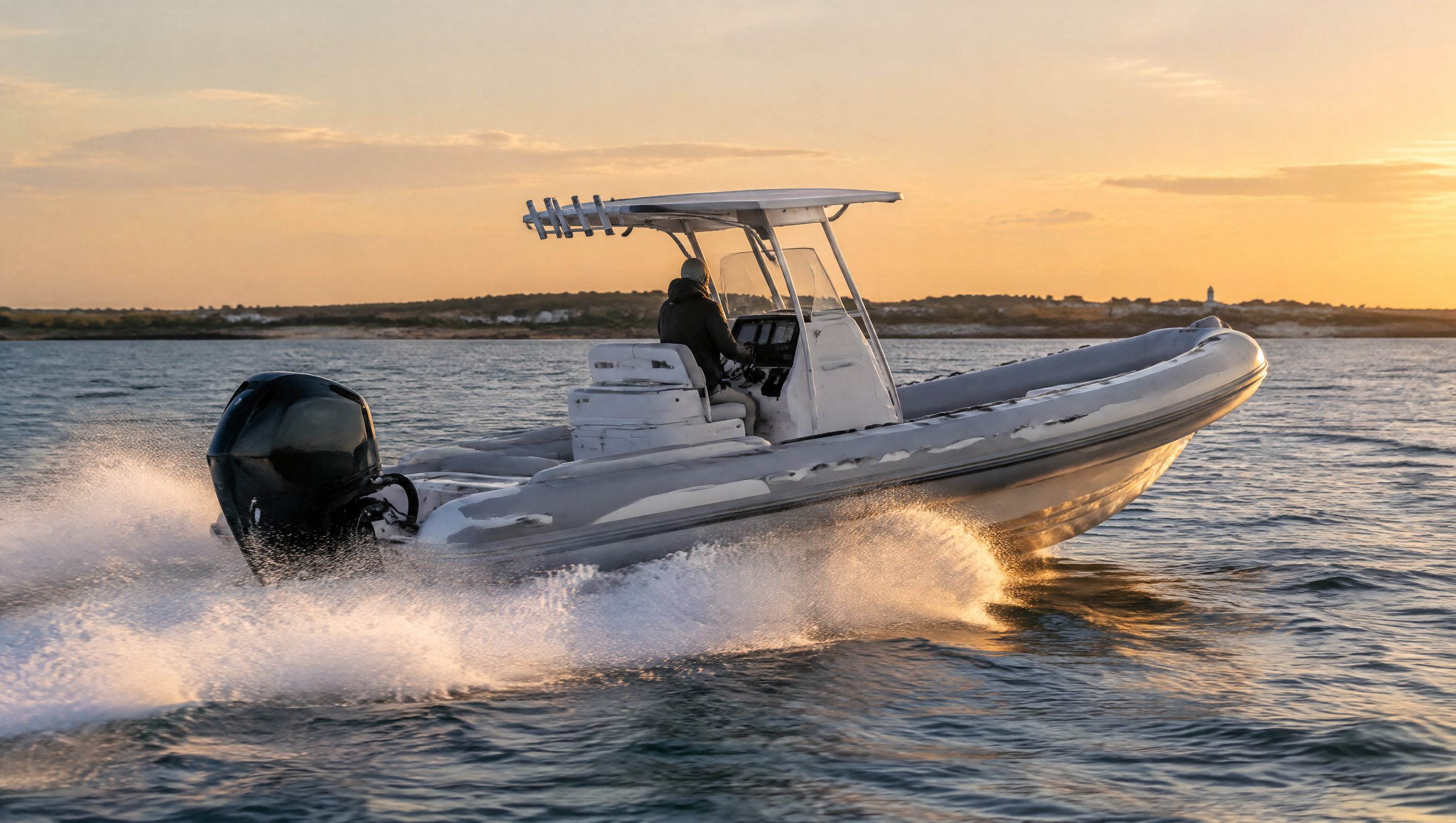 A rigid inflatable boat running across Vineyard Sound at golden hour